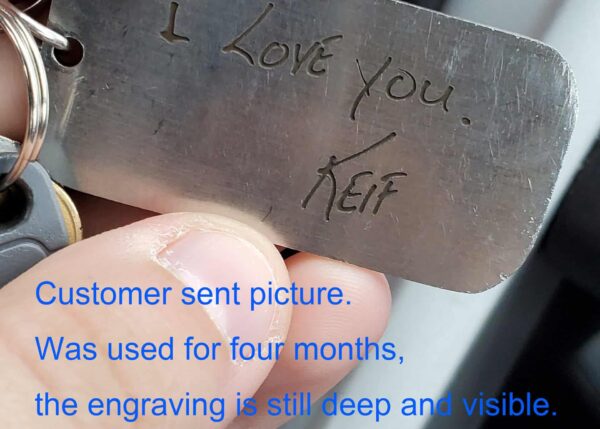 Deep engraved metal tag with I Love You message, demonstrating lasting quality after four months of use.