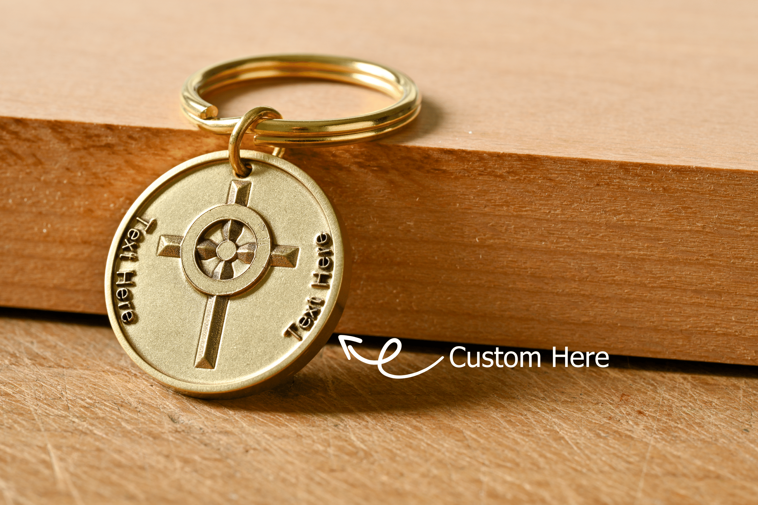 Gold circular keychain with a cross design and placeholder text for custom engraving