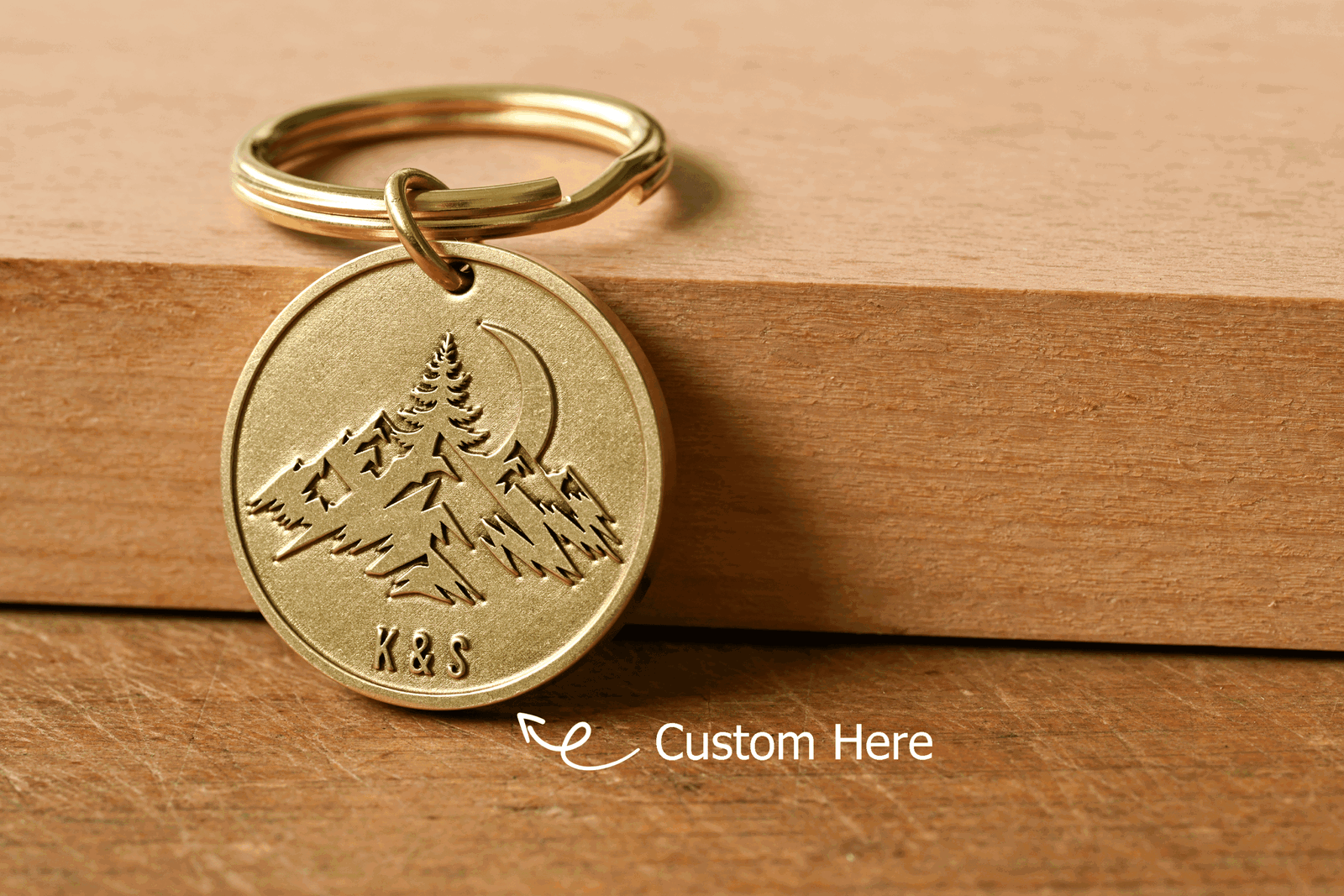 Brass keychain tag with engraved mountains and moon, featuring customizable initials K&S at the bottom