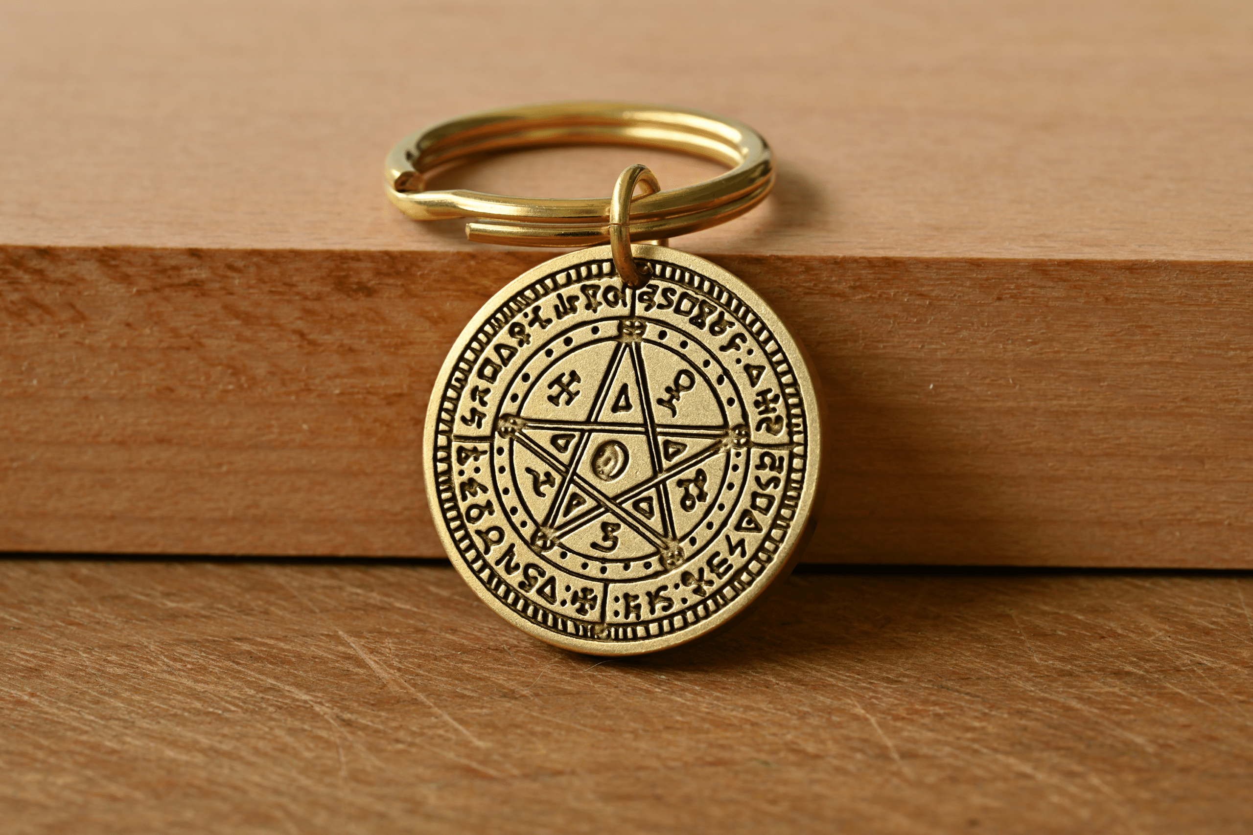 Brass key ring featuring a circular pendant engraved with a Solomonic pentagram seal and mystical symbols